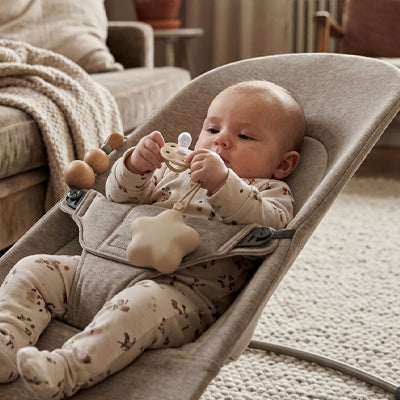 bébé joue avec sa tétine et sa Boite a tetine