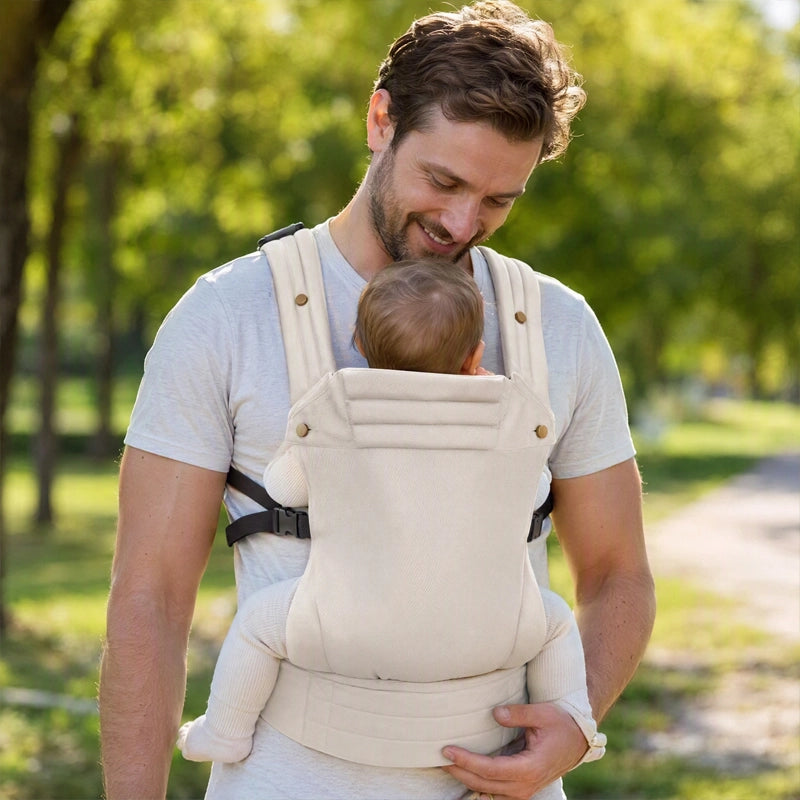 papa au parc avec bébé dans son porte bebe koala