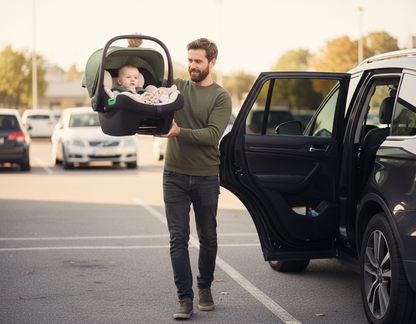 Papa dépose bébé dans la voiture installé dans le siège auto de sa poussette 3 en 1